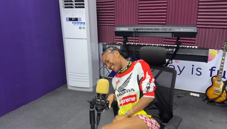 Ayra Starr smiling during a radio interview at Ultima Studios