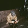 Asake counting cash in a Guess cap during the M$NEY era