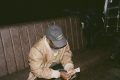 Asake counting cash in a Guess cap during the M$NEY era