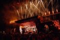 Burna Boy performing live on stage with fireworks and crowd