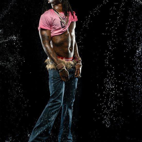 Rema in a studio water portrait.