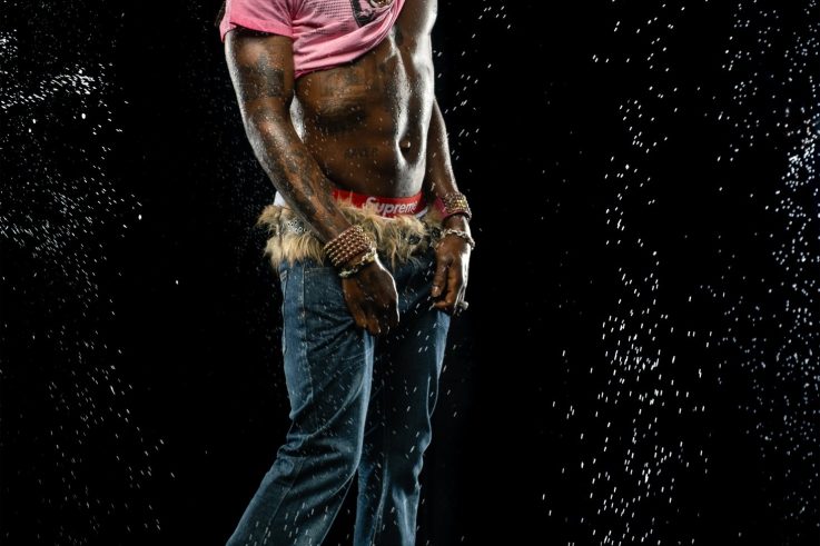 Rema in a studio water portrait.