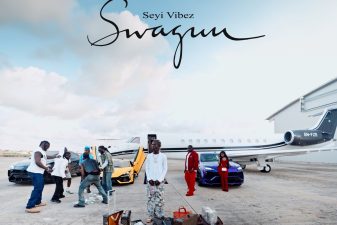 Seyi Vibez standing on an airport tarmac for the SWAGUU album cover