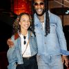 Burna Boy in double denim and tinted sunglasses posing with a guest at the Apple Music x Beats after-party in London