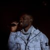 Dave performing on stage at the National Theatre in Lagos during his two-night run