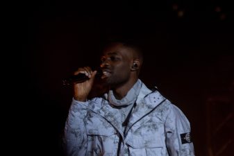 Dave performing on stage at the National Theatre in Lagos during his two-night run
