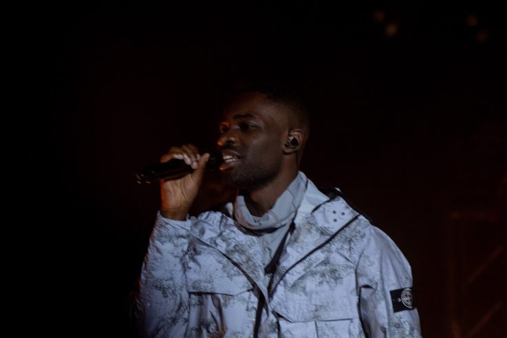 Dave performing on stage at the National Theatre in Lagos during his two-night run