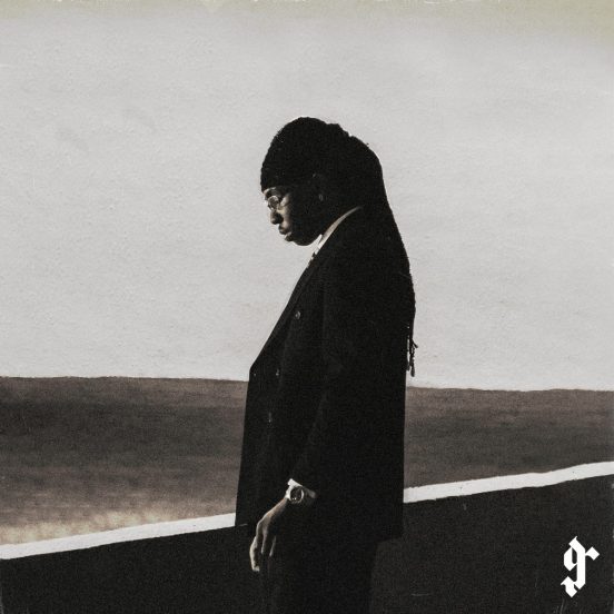 FOLA "9" album cover: FOLA in a dark suit with his head bowed against a pale sky, a gothic "9" in the corner.